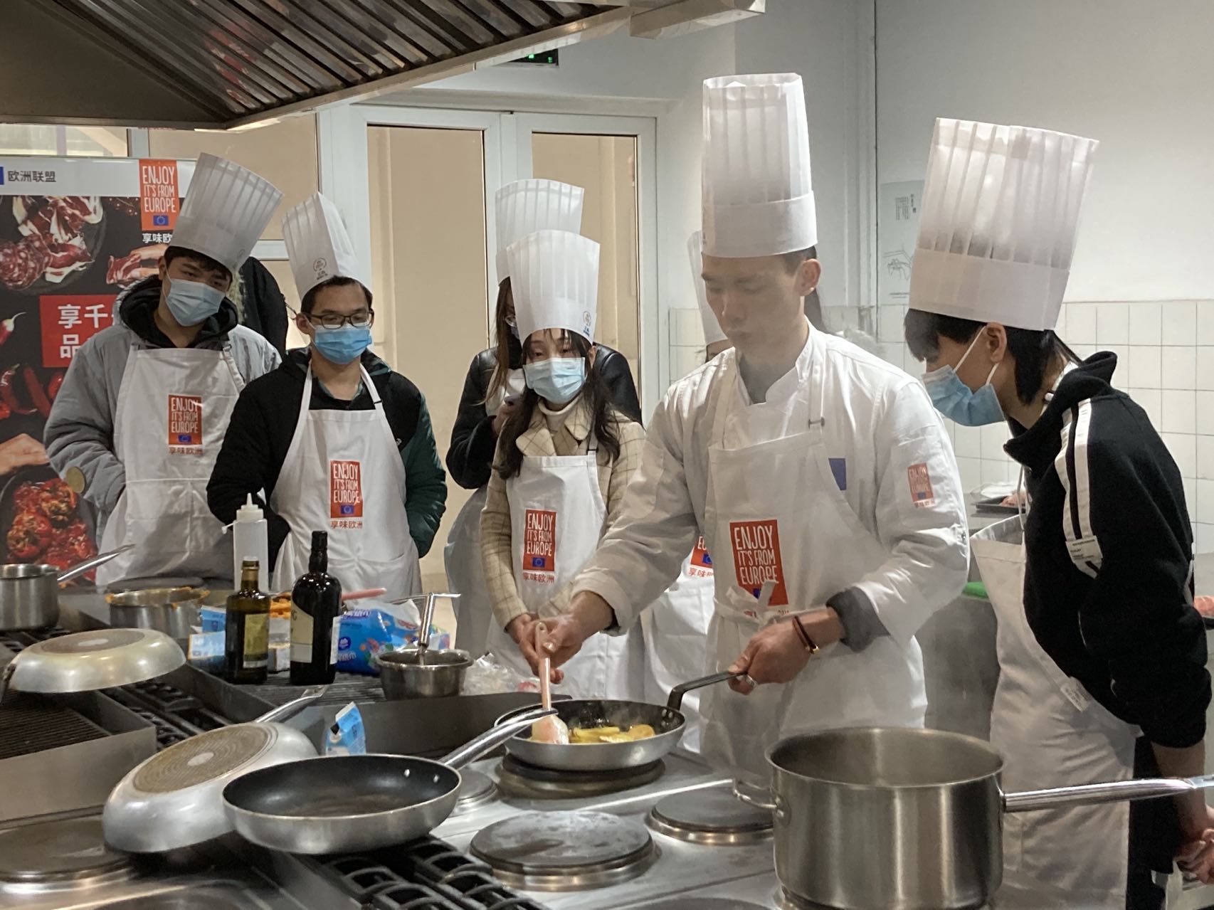 Cook showing students how to prepare a dish