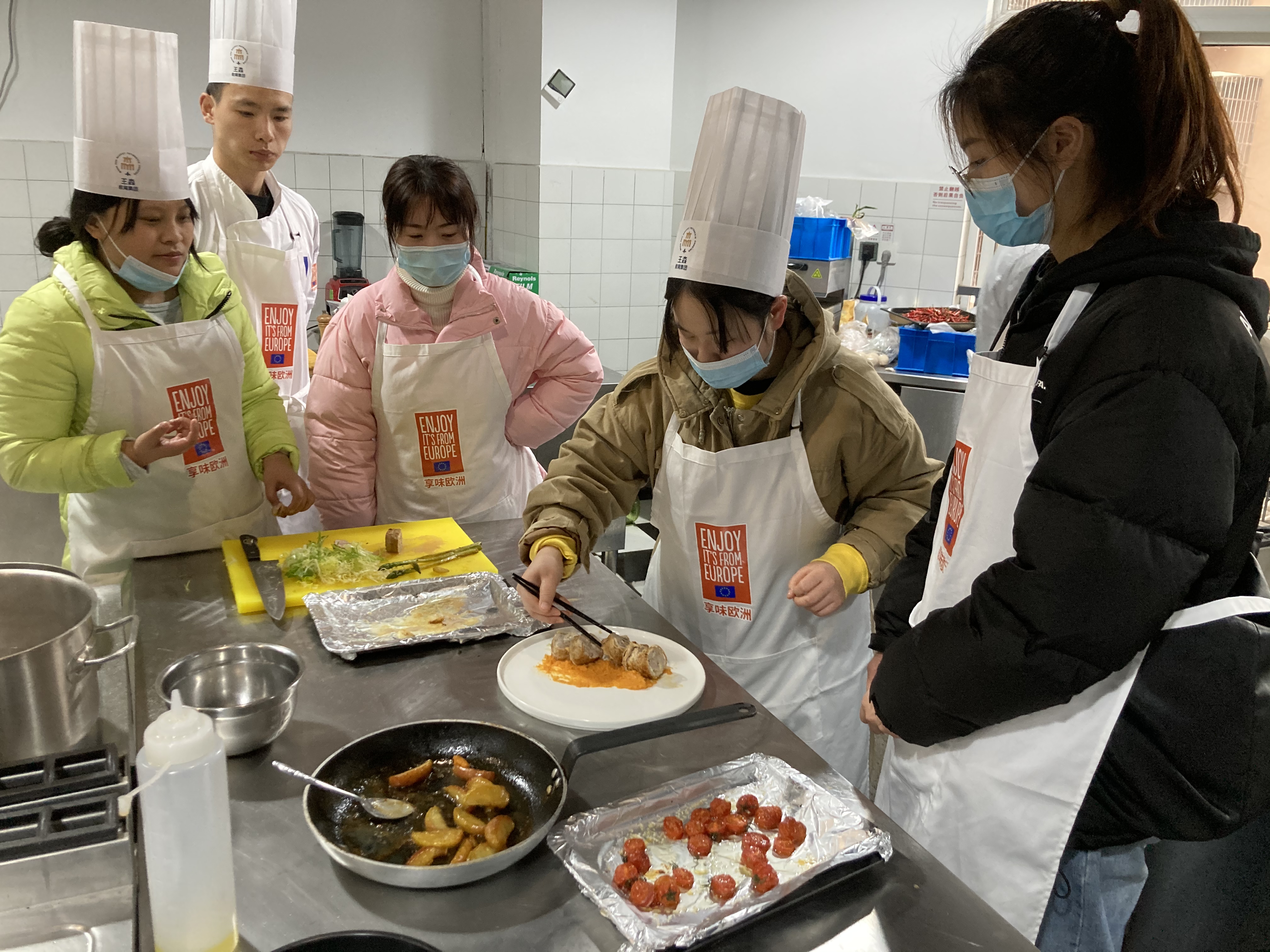Students preparing a dish together. 