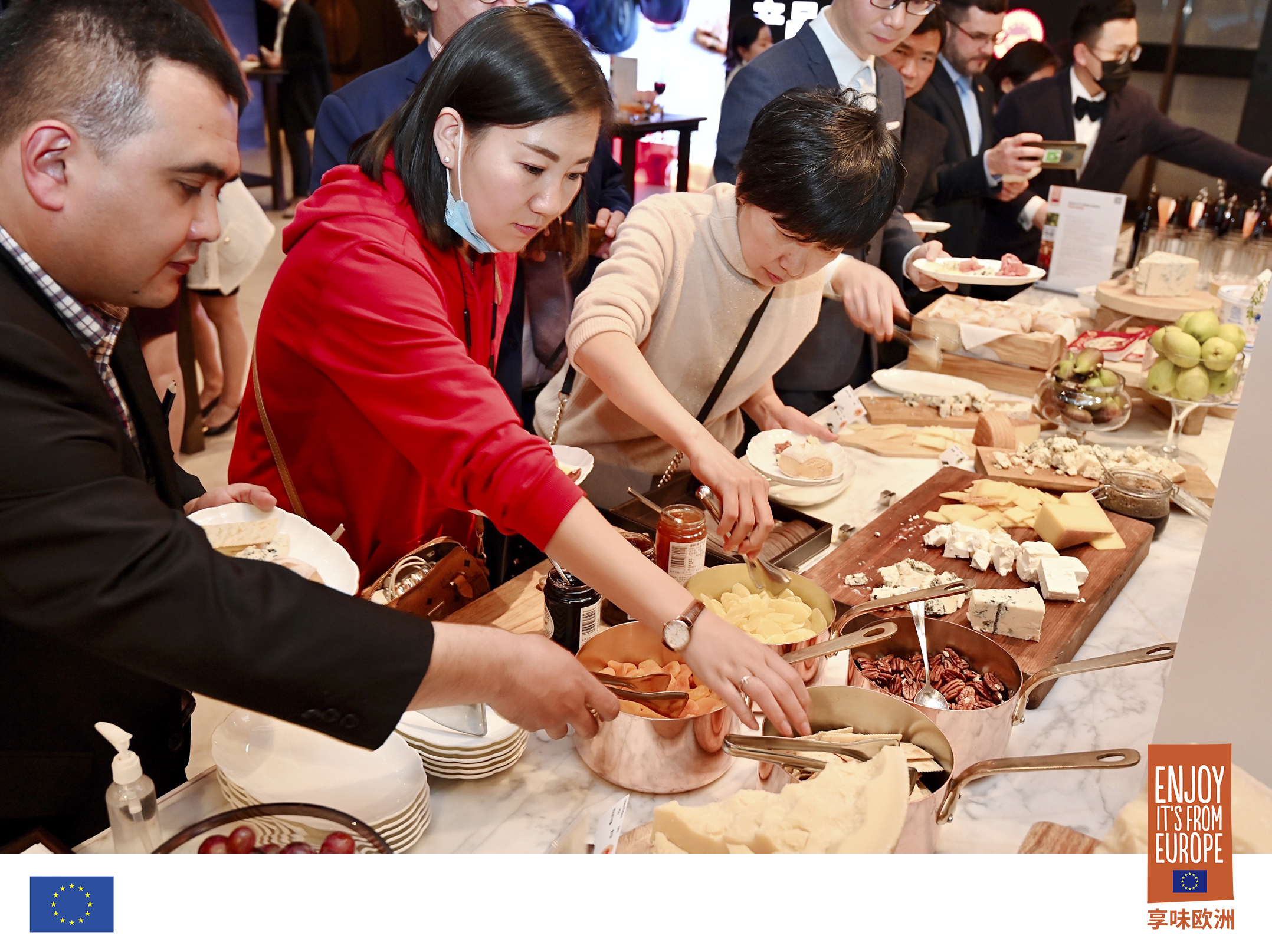 Participants selecting dishes from buffet.