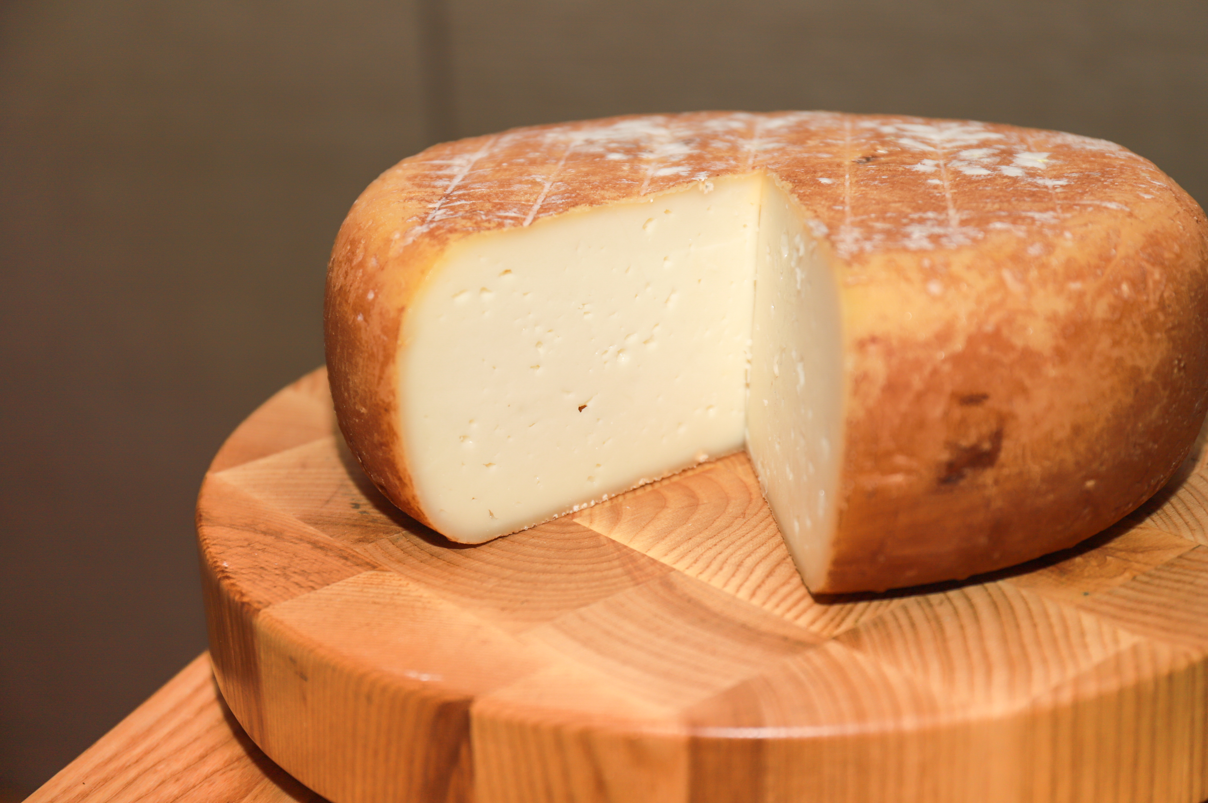 Cheese on a wooden plate.