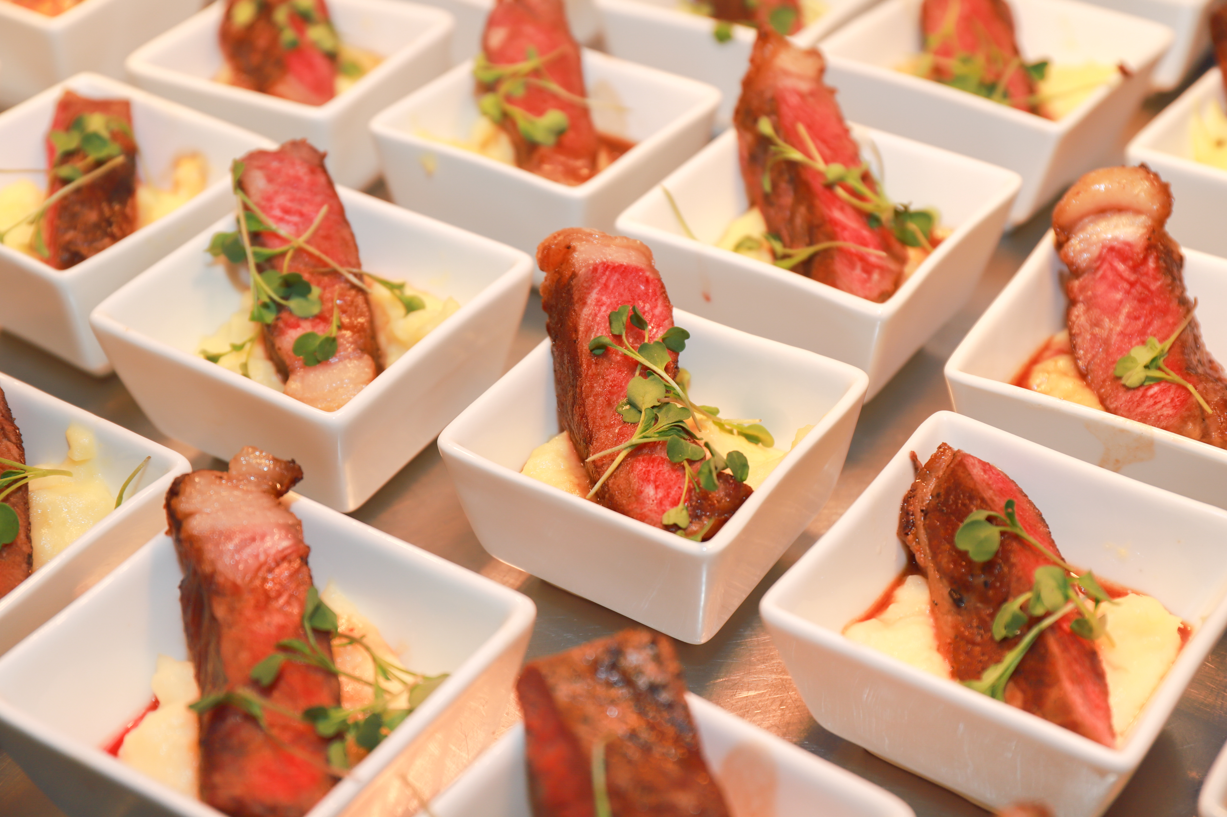 Meat presented in small plates as finger food.