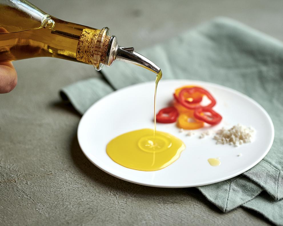 Olive oil being poured on a plate 